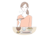 悲しい顔で食事をする女性